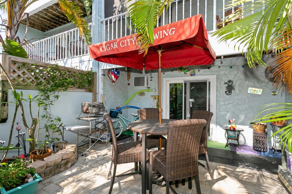 9166 Blind Pass Road St. Pete Beach, FL 33706 - Photo 33 of 37 an outdoor space with furniture and umbrella