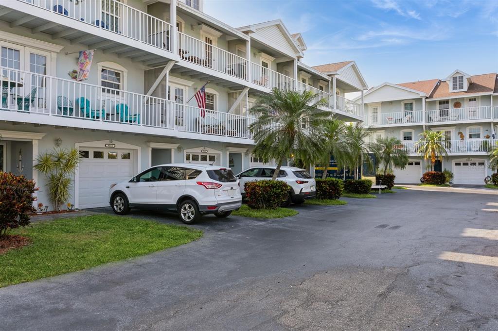 9166 Blind Pass Road St. Pete Beach, FL 33706 - Photo 34 of 37 a view of a cars park in front of a building