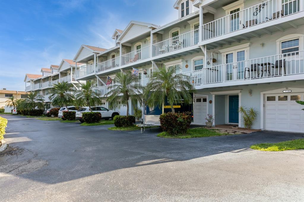 9166 Blind Pass Road St. Pete Beach, FL 33706 - Photo 35 of 37 a front view of a building with parked space