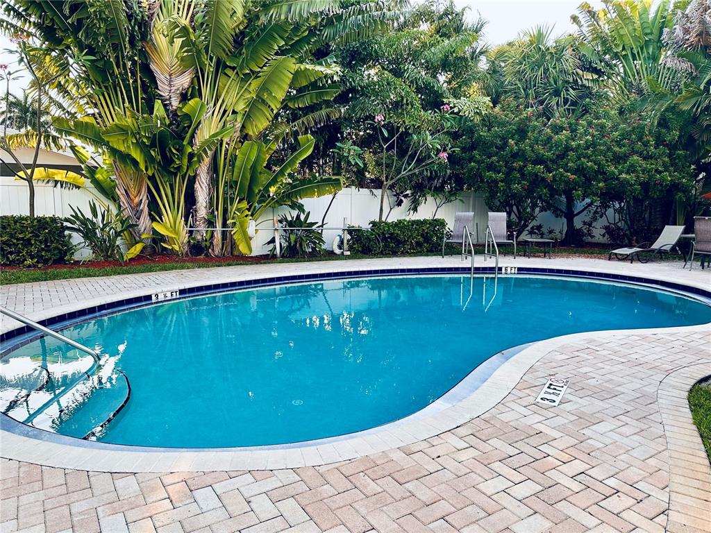 9166 Blind Pass Road St. Pete Beach, FL 33706 - Photo 37 of 37 a view of a swimming pool with a patio