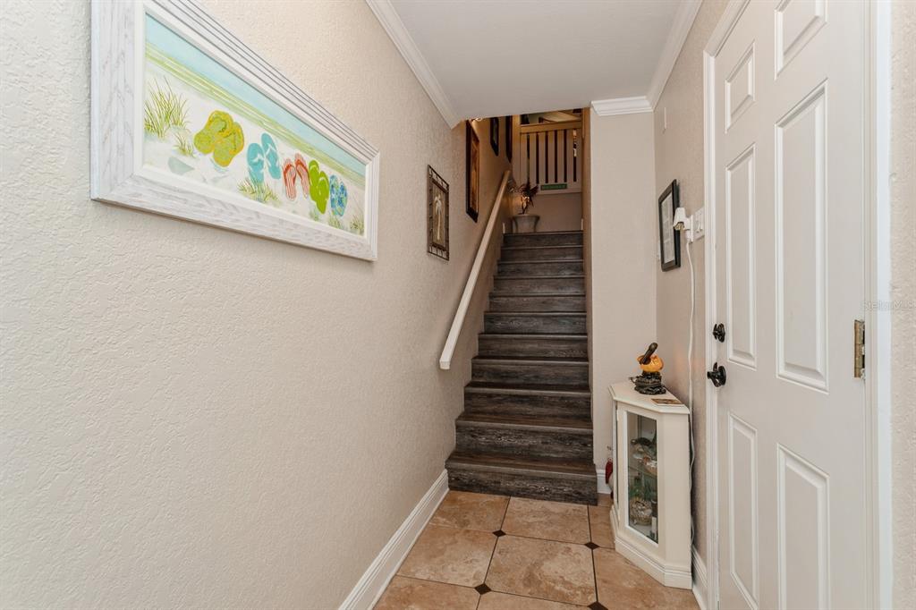 9166 Blind Pass Road St. Pete Beach, FL 33706 - Photo 4 of 37 a view of an entryway with wooden floor