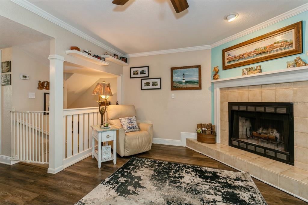 9166 Blind Pass Road St. Pete Beach, FL 33706 - Photo 7 of 37 a living room with furniture and a fireplace