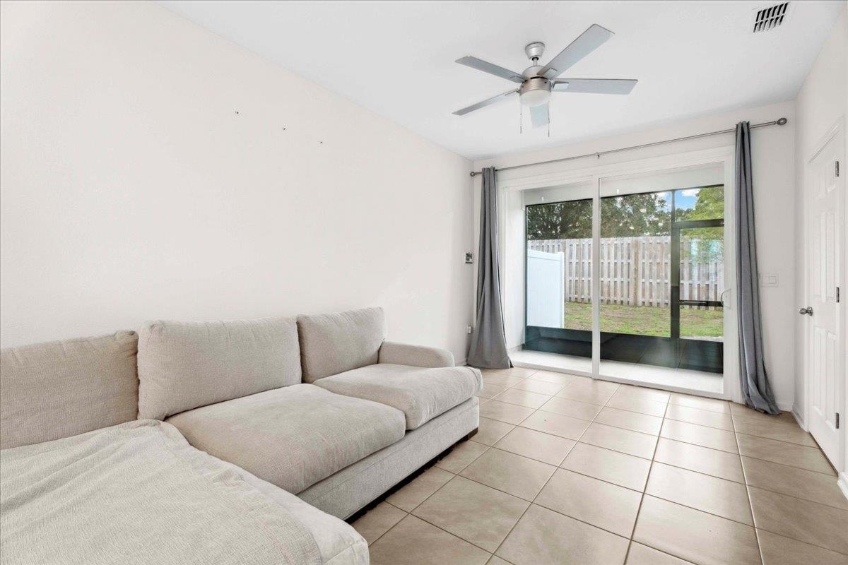 180 Stonegate Avenue St. Augustine, FL 32084 - Photo 12 of 38 a living room with furniture and a ceiling fan