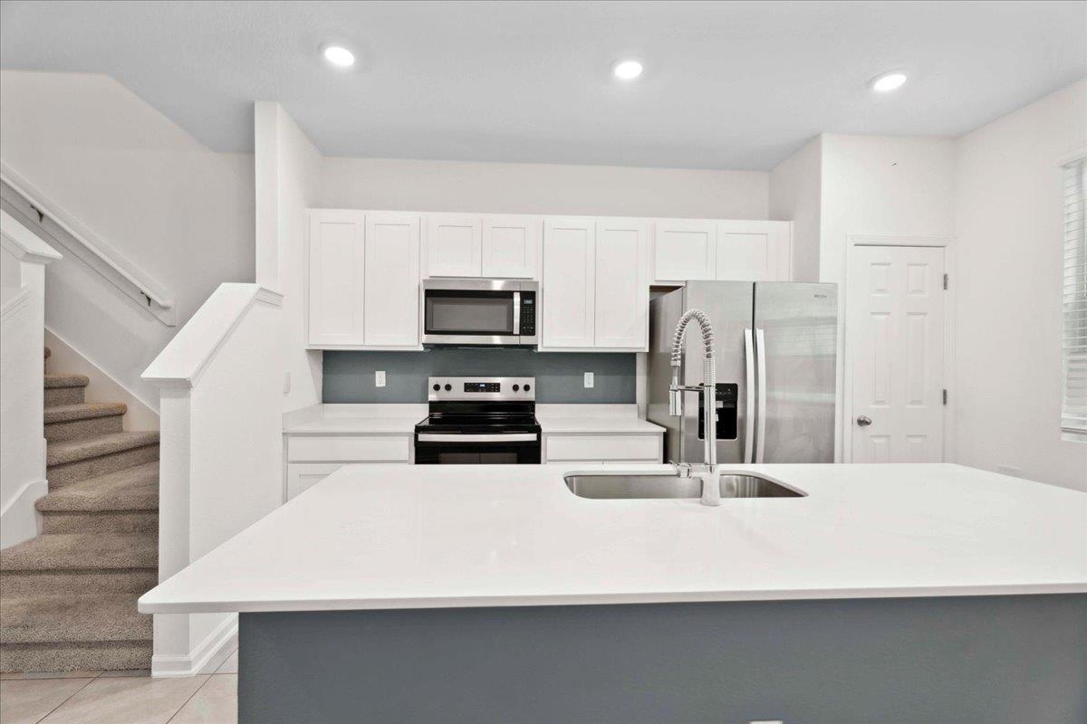 180 Stonegate Avenue St. Augustine, FL 32084 - Photo 16 of 38 a kitchen with stainless steel appliances a refrigerator sink and microwave