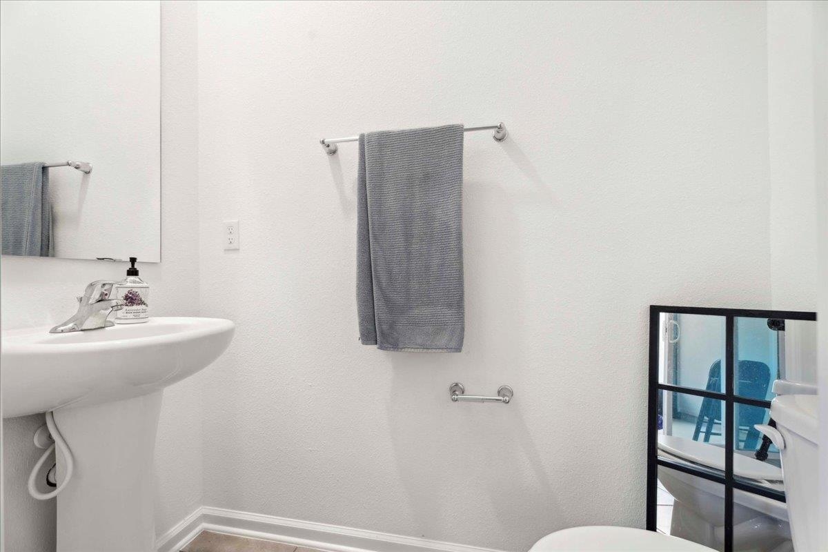 180 Stonegate Avenue St. Augustine, FL 32084 - Photo 29 of 38 a bathroom with a sink and mirror