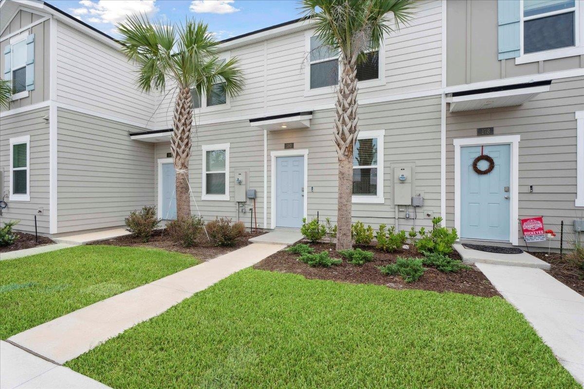 180 Stonegate Avenue St. Augustine, FL 32084 - Photo 3 of 38 a front view of a house with a yard and garage