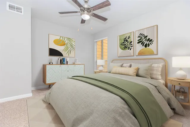 a bedroom with a bed and painting on the wall