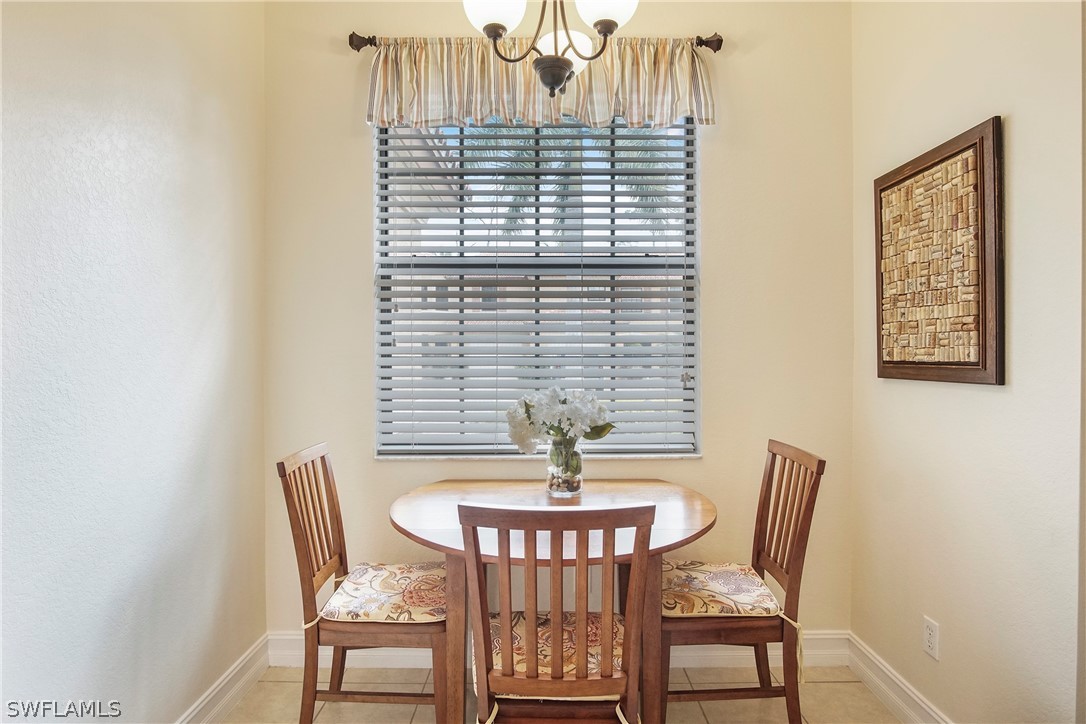 9070 Water Tupelo Road Fort Myers, FL 33912 - Photo 11 of 29 a view of a dining room with furniture and wooden floor