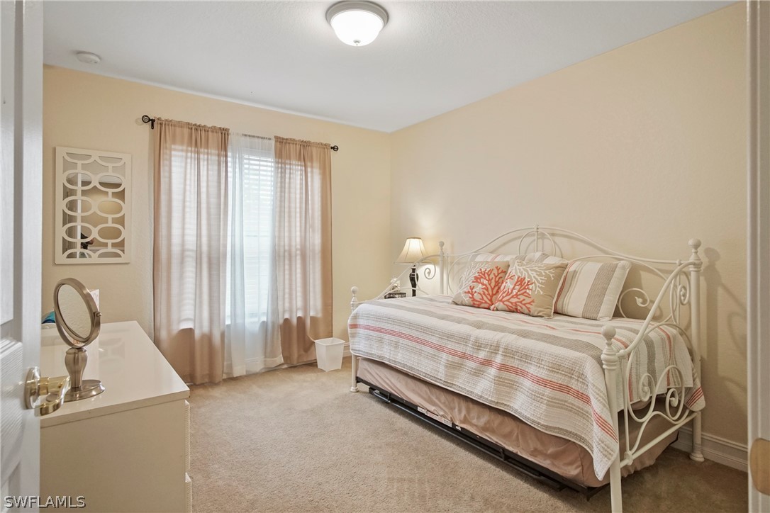 9070 Water Tupelo Road Fort Myers, FL 33912 - Photo 18 of 29 a bedroom with a bed and a window