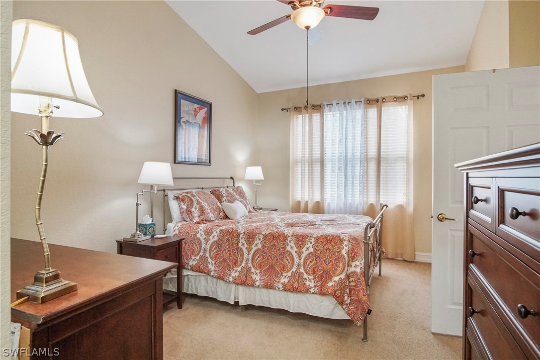 9070 Water Tupelo Road Fort Myers, FL 33912 - Photo 23 of 29 a bedroom with a bed and a chandelier