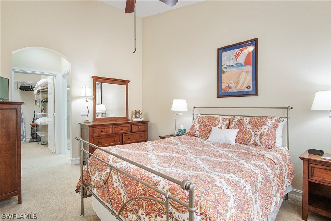 9070 Water Tupelo Road Fort Myers, FL 33912 - Photo 24 of 29 a bedroom with a bed and a chandelier