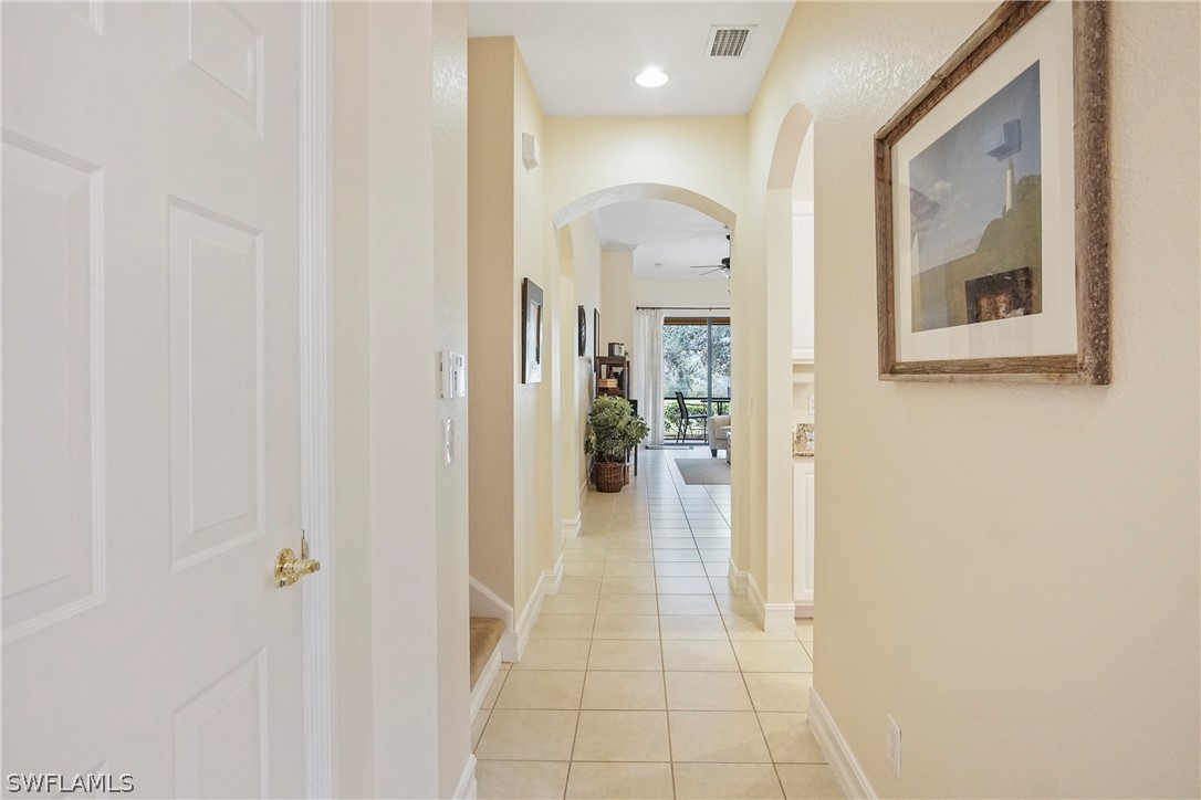 9070 Water Tupelo Road Fort Myers, FL 33912 - Photo 3 of 29 a view of a hallway with wooden shelves