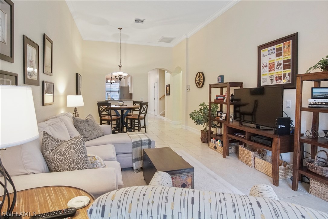 9070 Water Tupelo Road Fort Myers, FL 33912 - Photo 4 of 29 a living room with furniture and wooden floor