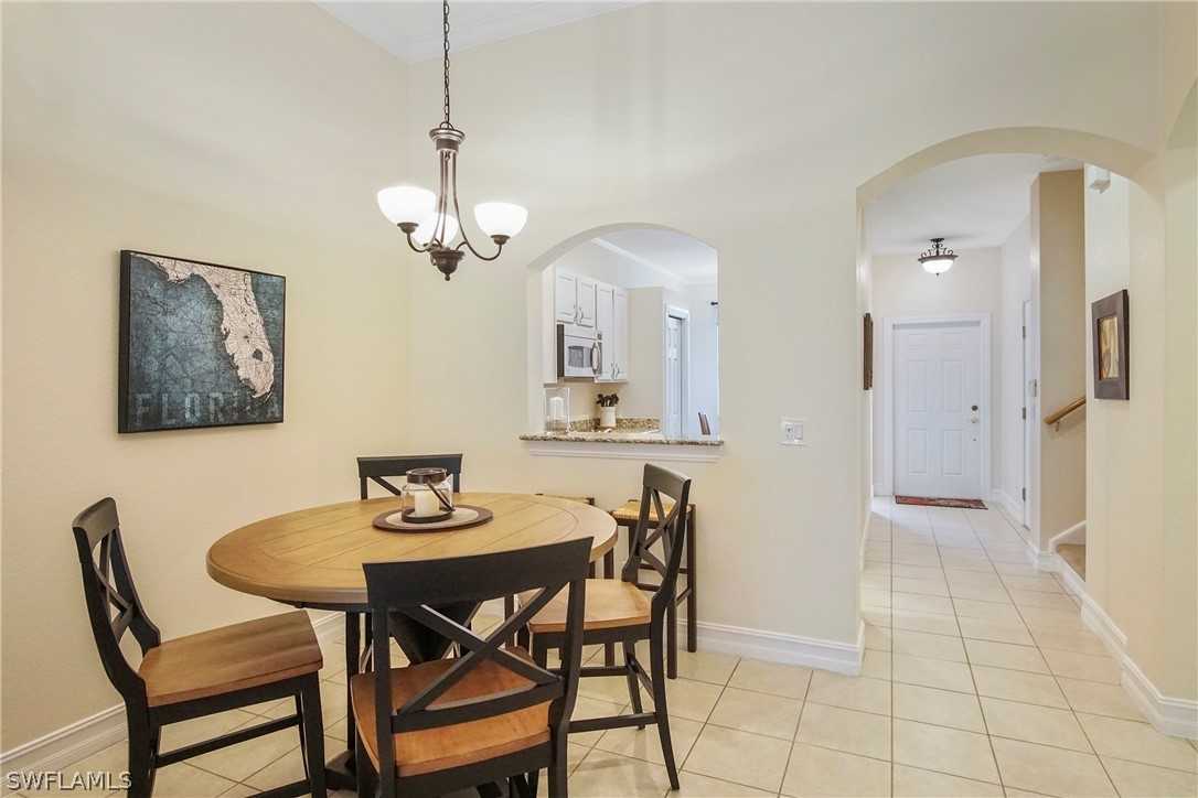 9070 Water Tupelo Road Fort Myers, FL 33912 - Photo 7 of 29 a view of a dining room with furniture and a chandelier