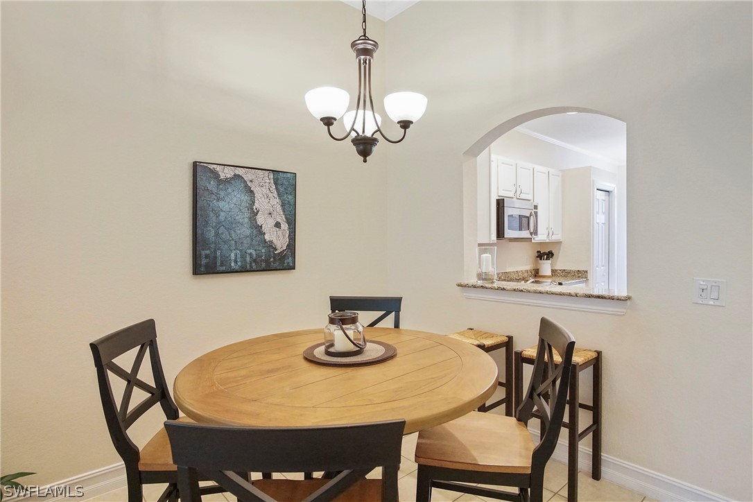 9070 Water Tupelo Road Fort Myers, FL 33912 - Photo 8 of 29 a view of a dining room with furniture and chandelier