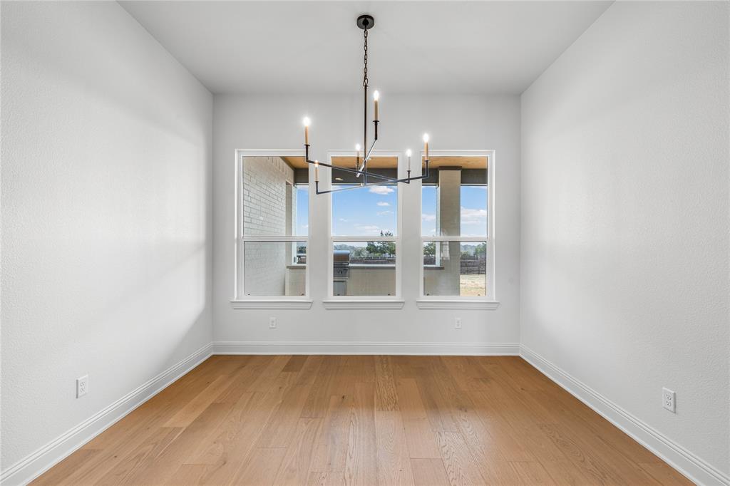 4720 Magnolia Trail Midlothian, TX 76065 - Photo 11 of 40 an empty room with wooden floor and windows
