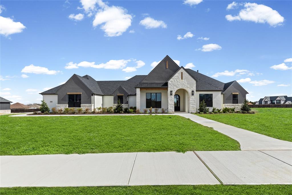 4720 Magnolia Trail Midlothian, TX 76065 - Photo 2 of 40 a front view of a house with a garden