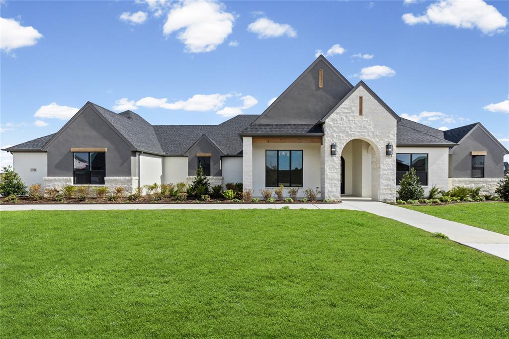 4720 Magnolia Trail Midlothian, TX 76065 - Photo 3 of 40 a front view of a house with yard patio and green space