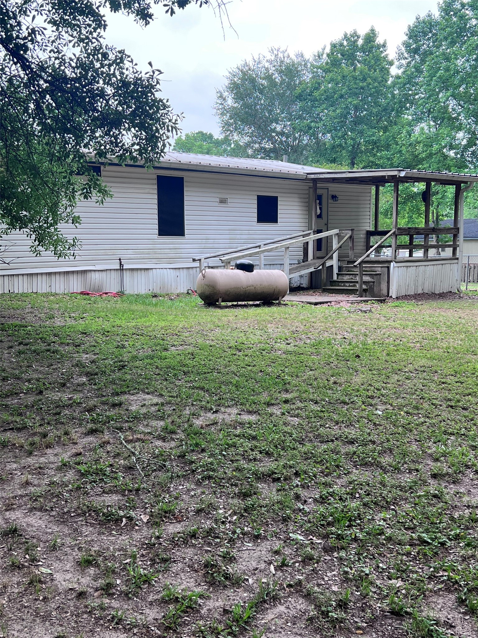 512 Cutter Drive Trinity, TX 75862 - Photo 8 of 21 Propane tank is for the gas stove in the kitchen. Covered back porch.