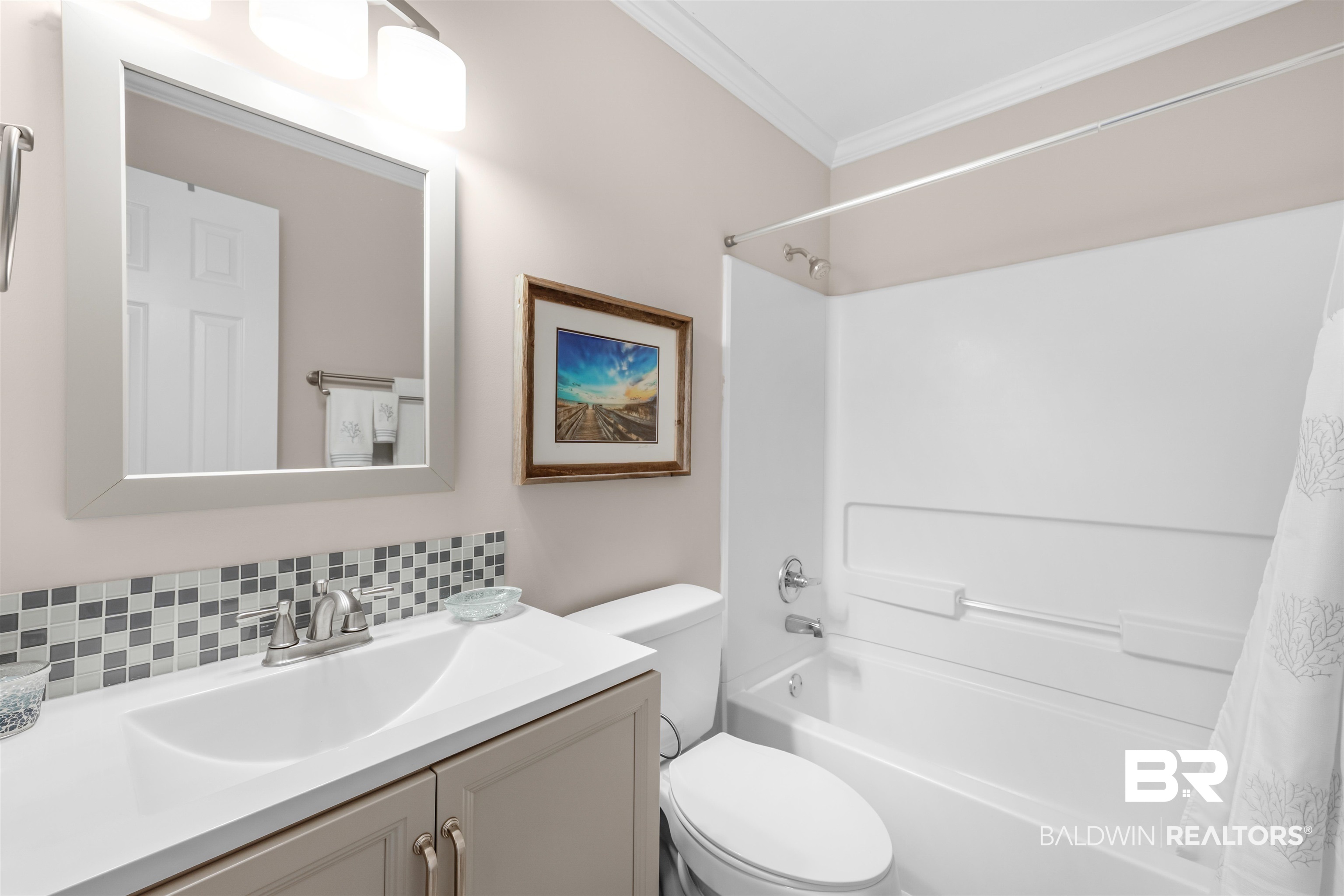 1517 Regency Road, Unit 68 Gulf Shores, AL 36542 - Photo 24 of 43 Full bathroom with tasteful backsplash, ornamental molding, vanity, shower / bath combo with shower curtain, and toilet