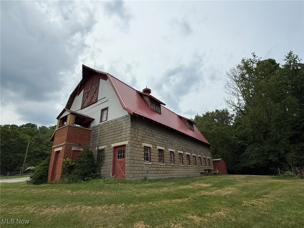 2597 Pyle Road Dover, OH 44622 - Photo 48 of 50 View of side of home featuring a lawn, a metal roof, a chimney, and a gambrel roof