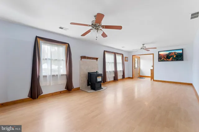 a view of an empty room with window and cabinet