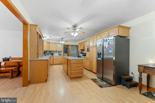 a view of kitchen with furniture and a refrigerator