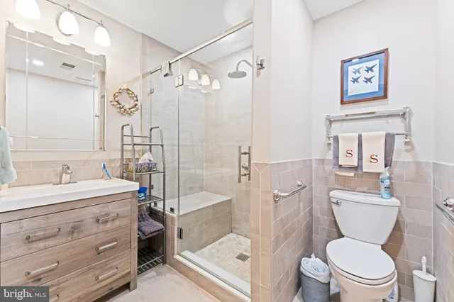 a bathroom with a granite countertop toilet a sink and a bathtub