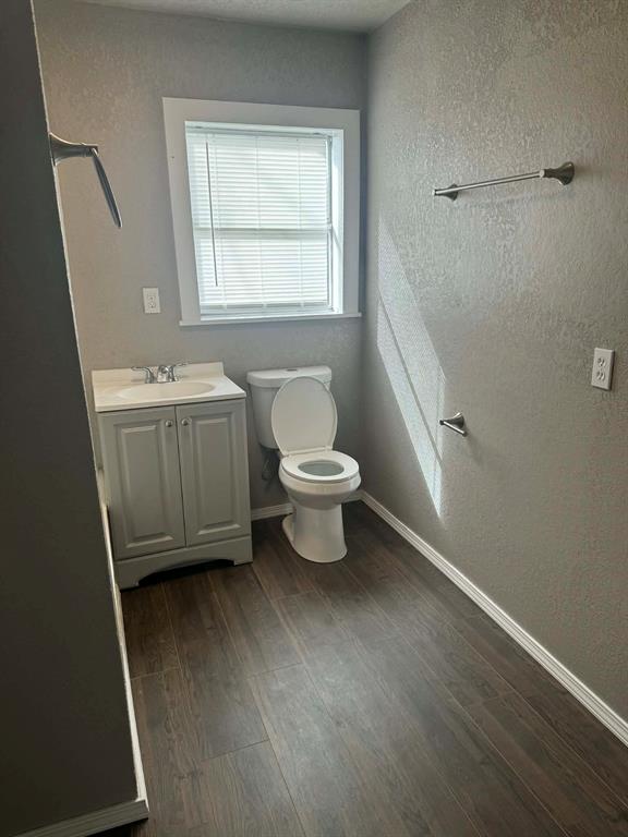 601 South Pine Street Comanche, TX 76442 - Photo 6 of 11 a bathroom with a granite countertop sink toilet and shower