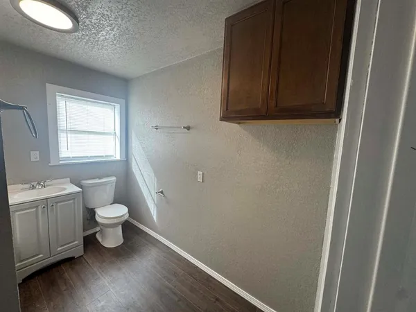 a bathroom with a toilet a sink and window