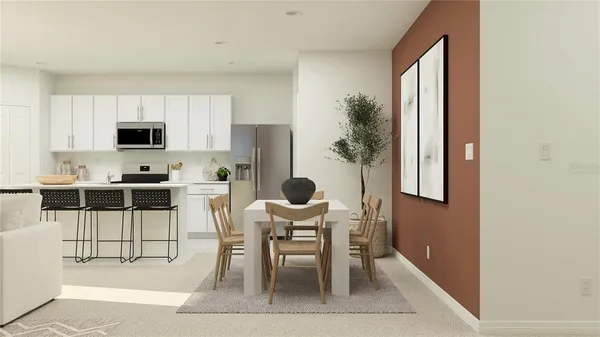 a kitchen with granite countertop a table and chairs in it