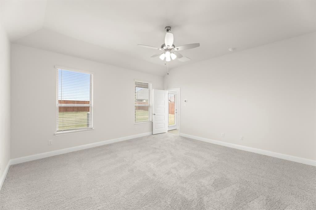 2029 Gladd Road Royse City, TX 75189 - Photo 13 of 27 an empty room with chandelier fan and windows