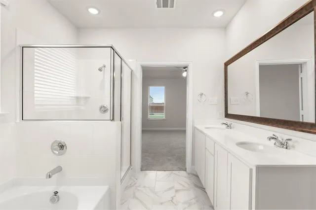 a bathroom with a bathtub and a sink