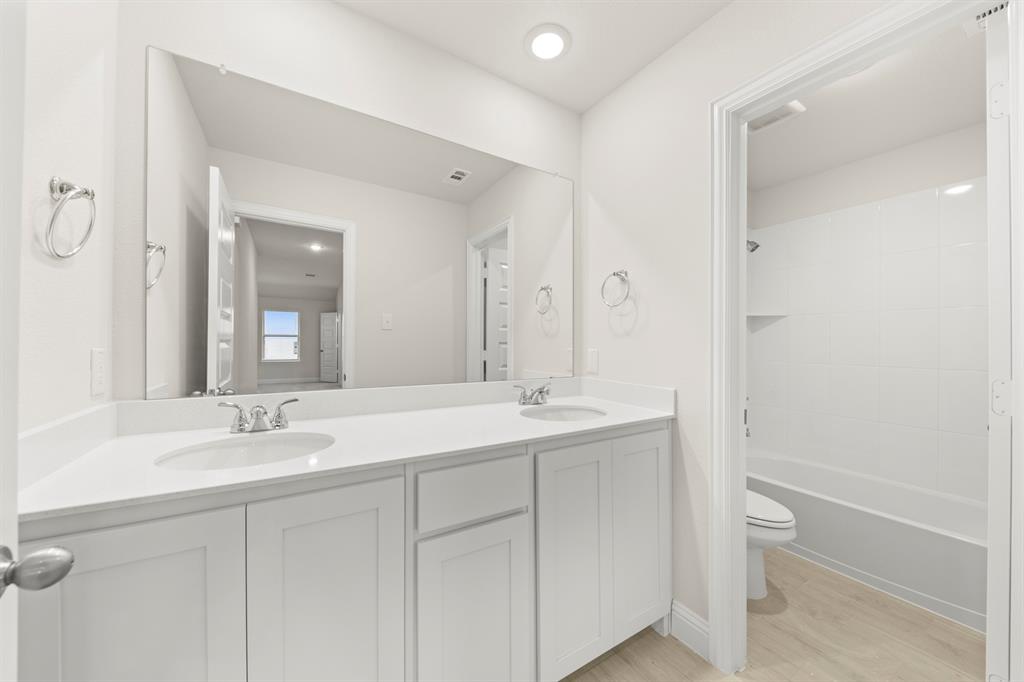 2029 Gladd Road Royse City, TX 75189 - Photo 22 of 27 a bathroom with a granite countertop sink toilet and shower