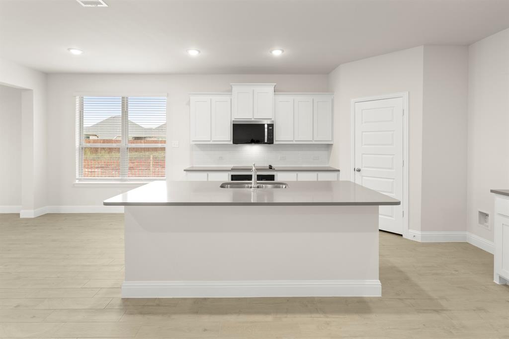 2029 Gladd Road Royse City, TX 75189 - Photo 4 of 27 a kitchen with stainless steel appliances granite countertop a sink a stove and a refrigerator