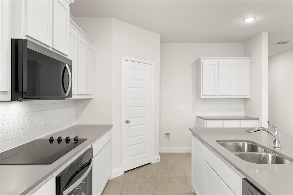 2029 Gladd Road Royse City, TX 75189 - Photo 6 of 27 a kitchen with a sink stove and microwave