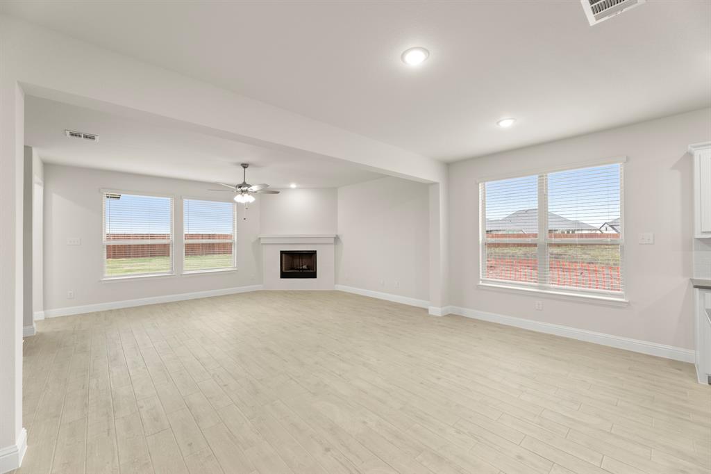 2029 Gladd Road Royse City, TX 75189 - Photo 7 of 27 an empty room with windows and fireplace