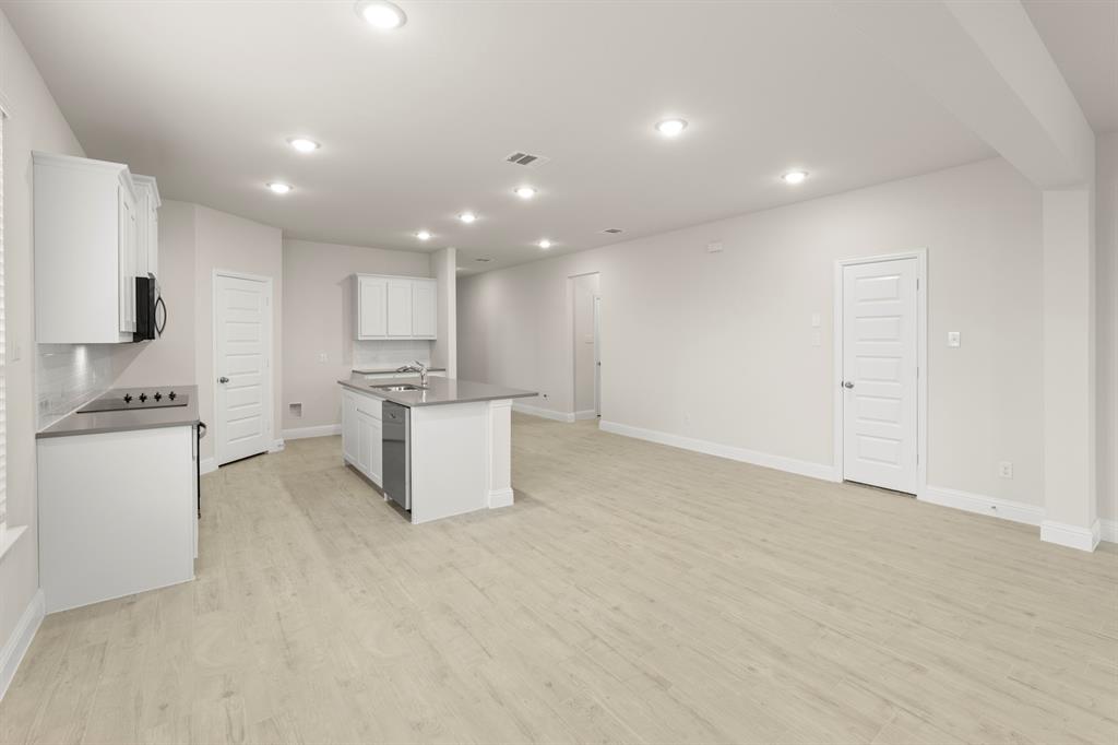 2029 Gladd Road Royse City, TX 75189 - Photo 8 of 27 a kitchen with a refrigerator and white cabinets
