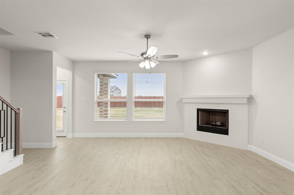2029 Gladd Road Royse City, TX 75189 - Photo 9 of 27 an empty room with chandelier fan and windows