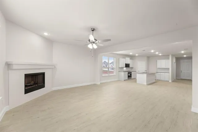 a view of a kitchen with a sink and a fireplace