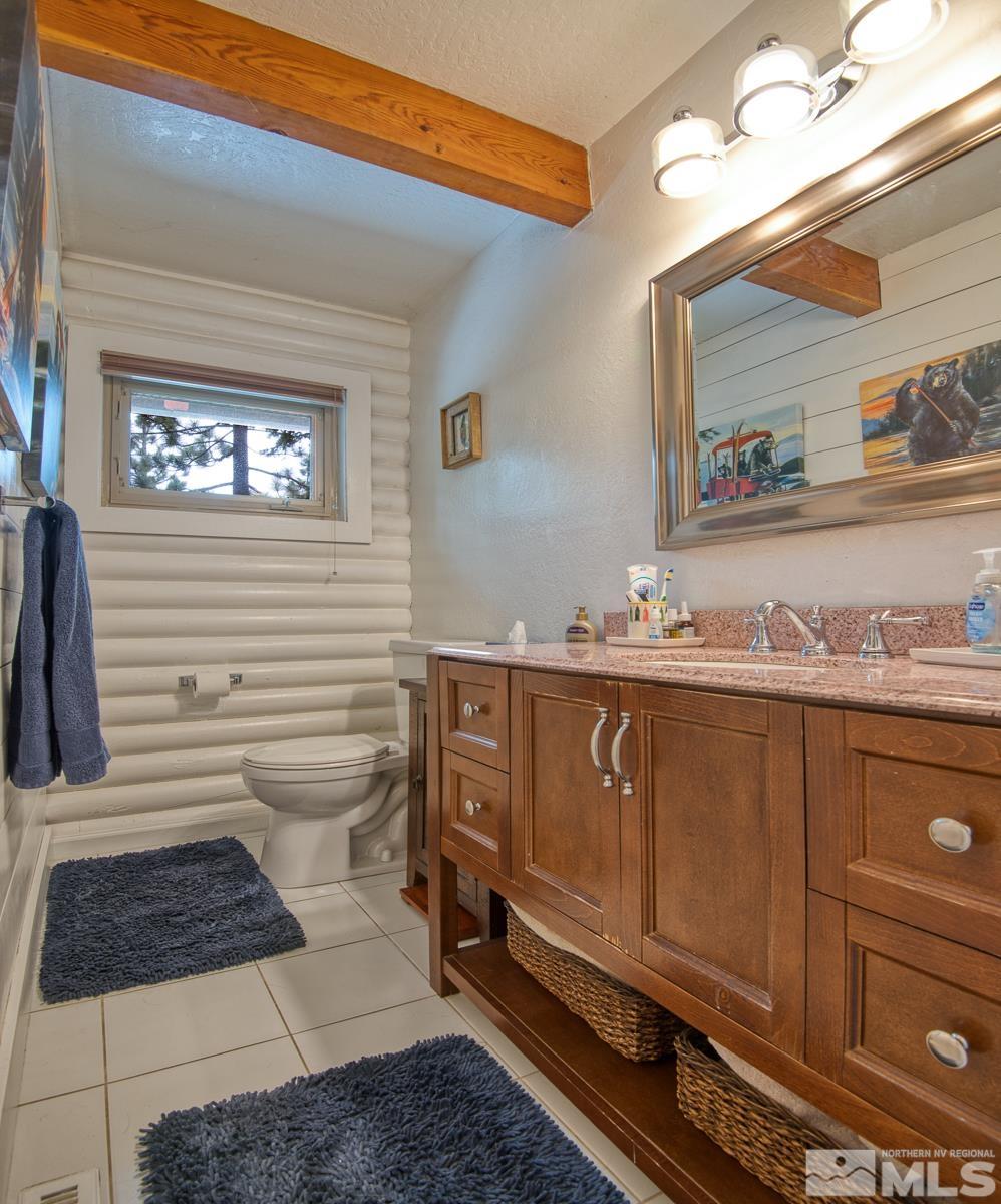 618 Jeff Lane Stateline, NV 89449 - Photo 15 of 37 a bathroom with a sink a mirror and a toilet