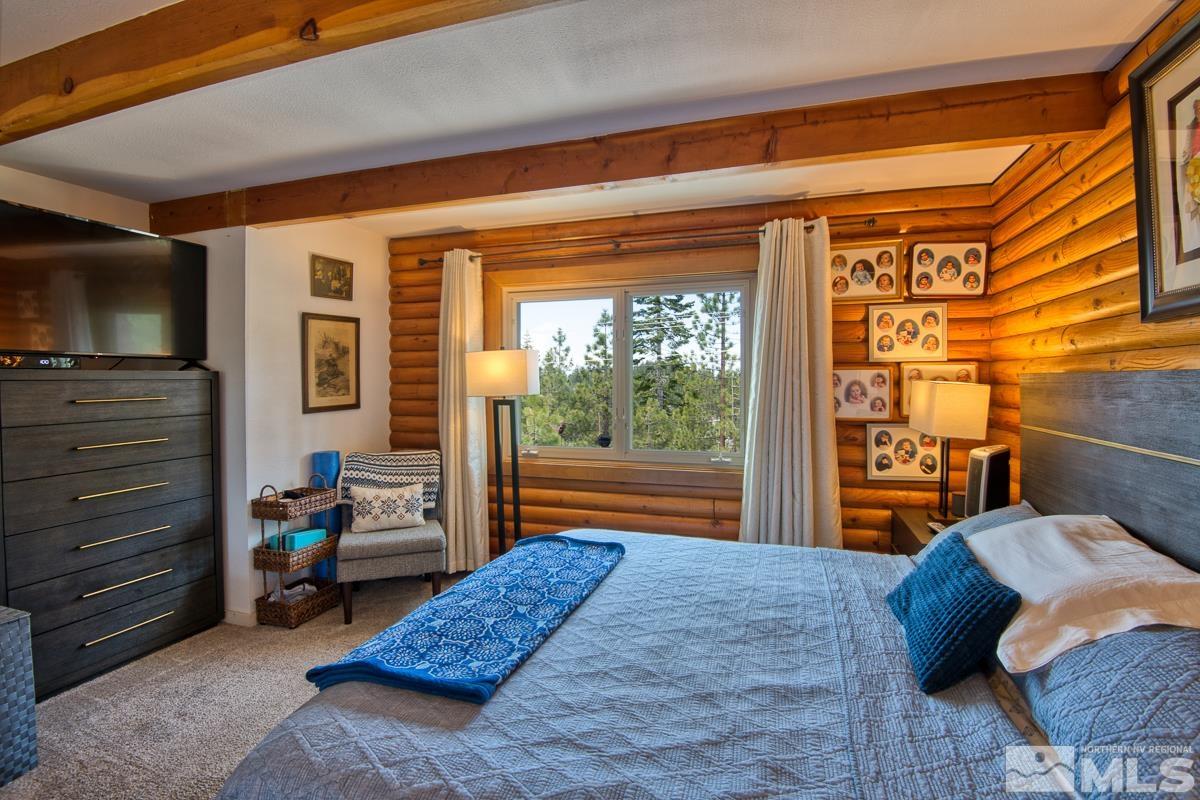 618 Jeff Lane Stateline, NV 89449 - Photo 17 of 37 a bedroom with a bed and large windows