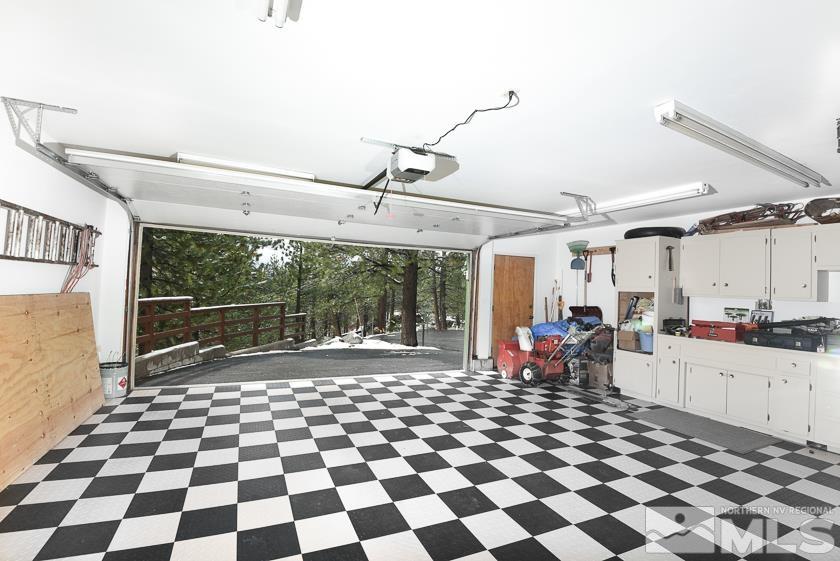 618 Jeff Lane Stateline, NV 89449 - Photo 26 of 37 a living room with a black white checkered floor with a gaming machine and dining chair