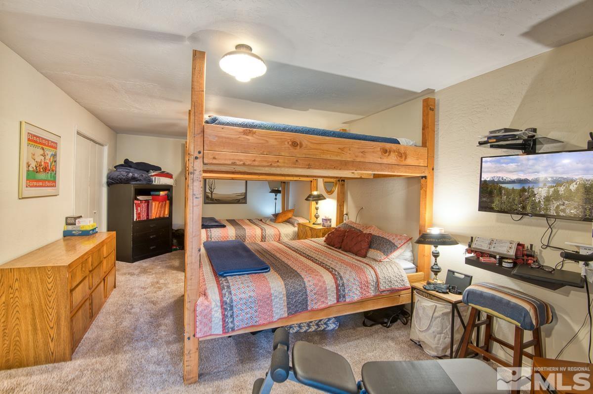 618 Jeff Lane Stateline, NV 89449 - Photo 30 of 37 a bedroom with a bed and wooden floor