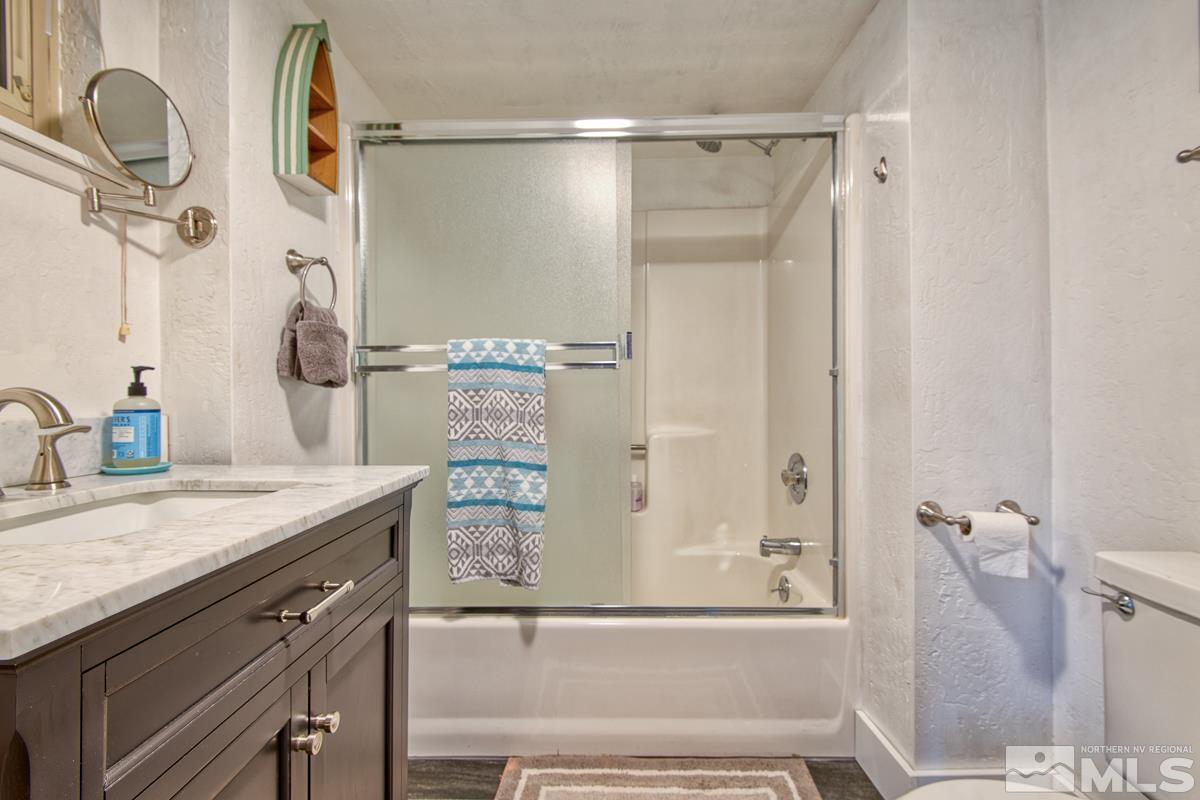 618 Jeff Lane Stateline, NV 89449 - Photo 31 of 37 a bathroom with a granite countertop sink and a mirror