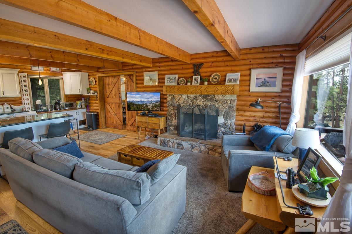 618 Jeff Lane Stateline, NV 89449 - Photo 8 of 37 a living room with fireplace furniture and a large window