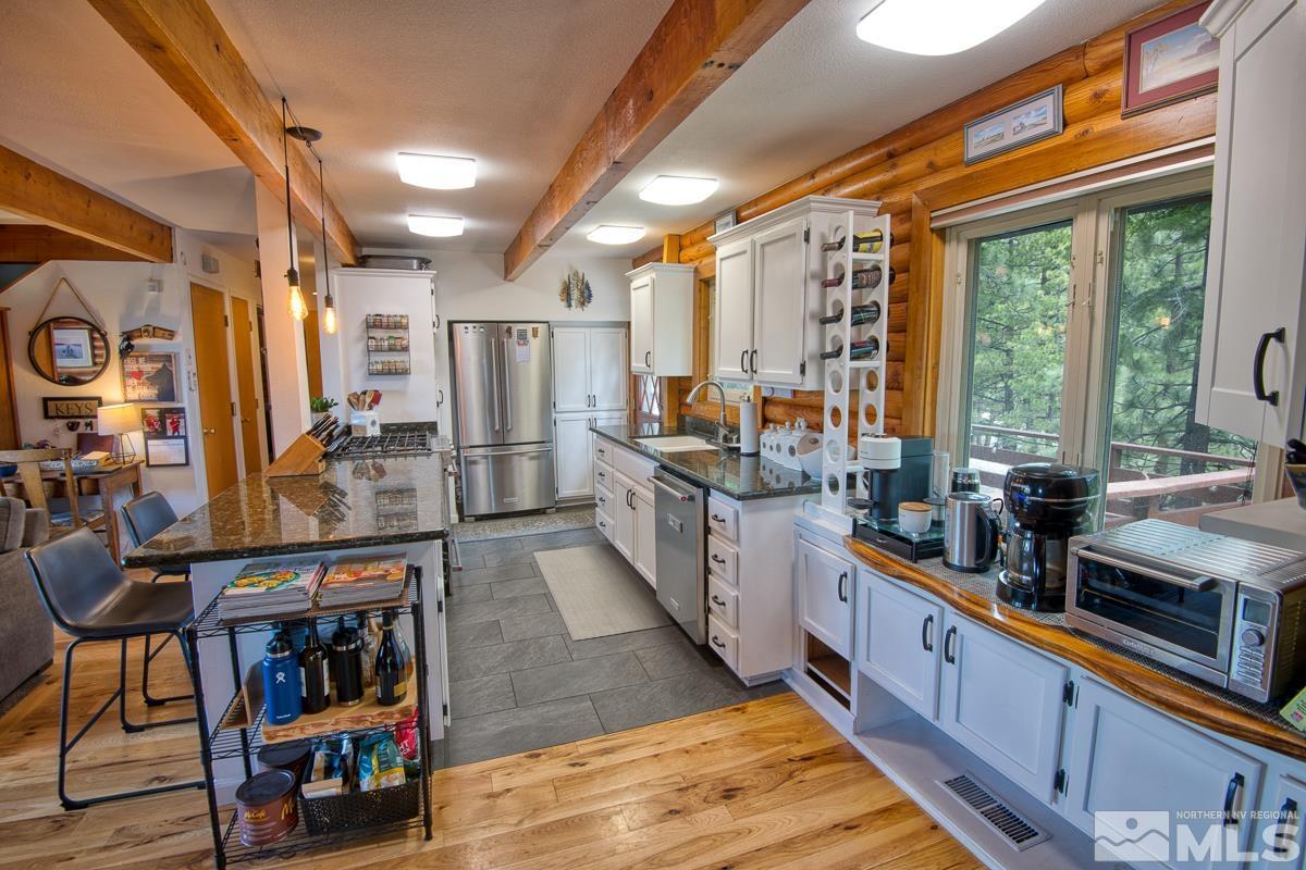 618 Jeff Lane Stateline, NV 89449 - Photo 10 of 37 a kitchen with stainless steel appliances granite countertop a stove and cabinets