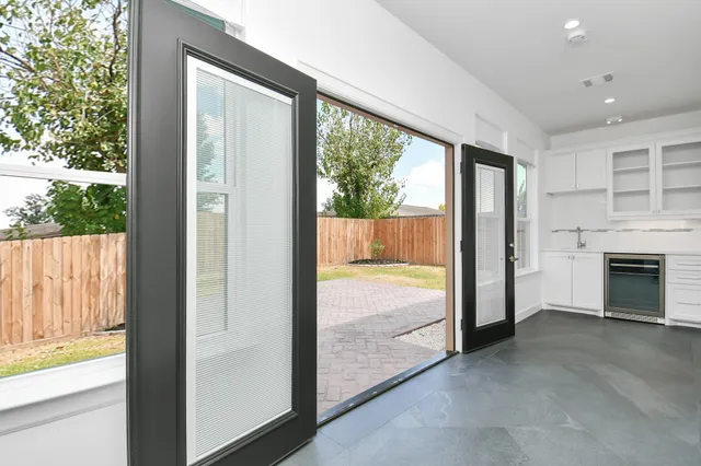 a view of an empty room with a fireplace and a large window