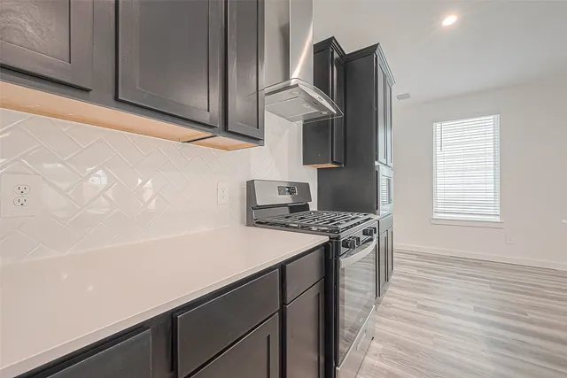 a kitchen with stainless steel appliances a stove and a refrigerator
