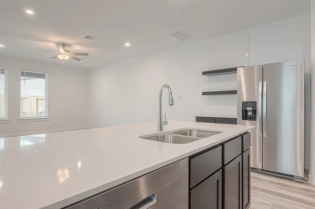 a kitchen with a sink and a refrigerator